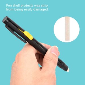 May include: A black pen-shaped tool with a yellow accent, designed to protect a wax strip. The text on the image reads: "Pen shell protects wax strip from being easily damaged."