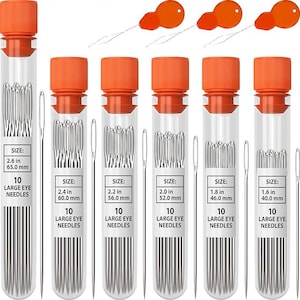 May include: Six clear plastic tubes with orange caps, each containing ten large eye needles. Labels indicate sizes from 1.6 inches to 2.6 inches. Three orange needle threaders are positioned at the top, and individual needles are shown beside each tube.