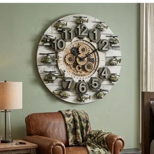 May include: A large round wall clock with a white wood-plank background, featuring twelve raised dark gray numbers and small green military helicopter figures positioned between each hour. The center displays exposed bronze-colored gears and text.