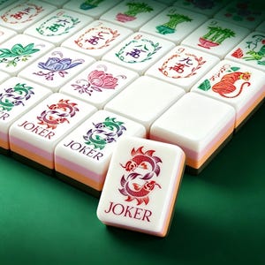 May include: A set of rectangular mahjong tiles with white faces and multi-layered sides in pink, orange, and dark brown. The tiles feature colorful illustrations of flowers, bamboo, dragons, and tigers, with several tiles labeled JOKER in red text.