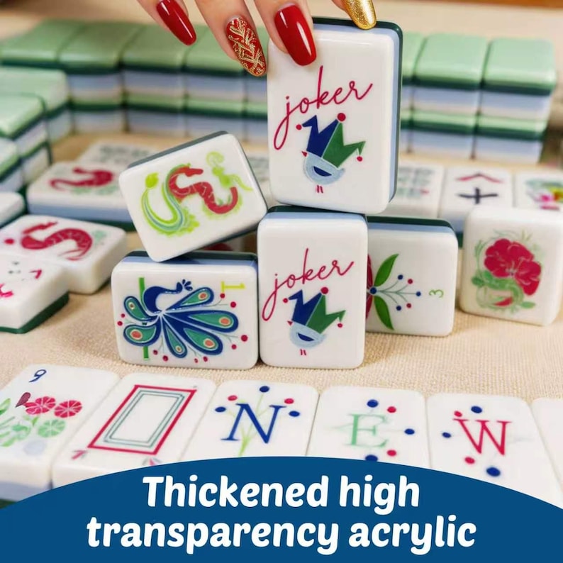 May include: A set of white acrylic mahjong tiles featuring colorful illustrations of jokers, dragons, peacocks, and floral patterns. Some tiles display the text "joker" in red script, while others show letters spelling "NEW" and various numbers.