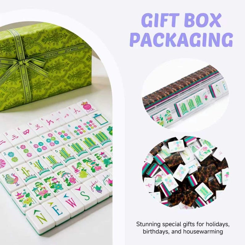 May include: A set of white mahjong tiles with colorful illustrations of bamboo, flowers, and characters, accompanied by a green gift box with a ribbon. The text GIFT BOX PACKAGING is visible. The tiles feature brown patterned backs and green edges.