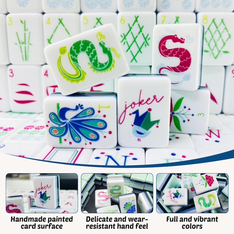 May include: A collection of white Mahjong tiles featuring colorful hand-painted designs including a green dragon, a red dragon, a blue peacock, and a joker tile with a jester hat icon and the word joker written in red script lettering.