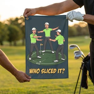 May include: A dark blue rectangular golf towel featuring a cartoon illustration of three golfers in lime green shirts and grey pants pointing at each other on a green. The text "WHO SLICED IT?" is printed in yellow at the bottom with a metal grommet.