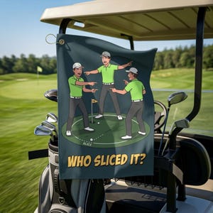 May include: A dark blue golf towel featuring a cartoon illustration of three people in green shirts and grey pants pointing at each other on a golf course. The text "WHO SLICED IT?" is printed in yellow at the bottom, with a "SLICE" label.