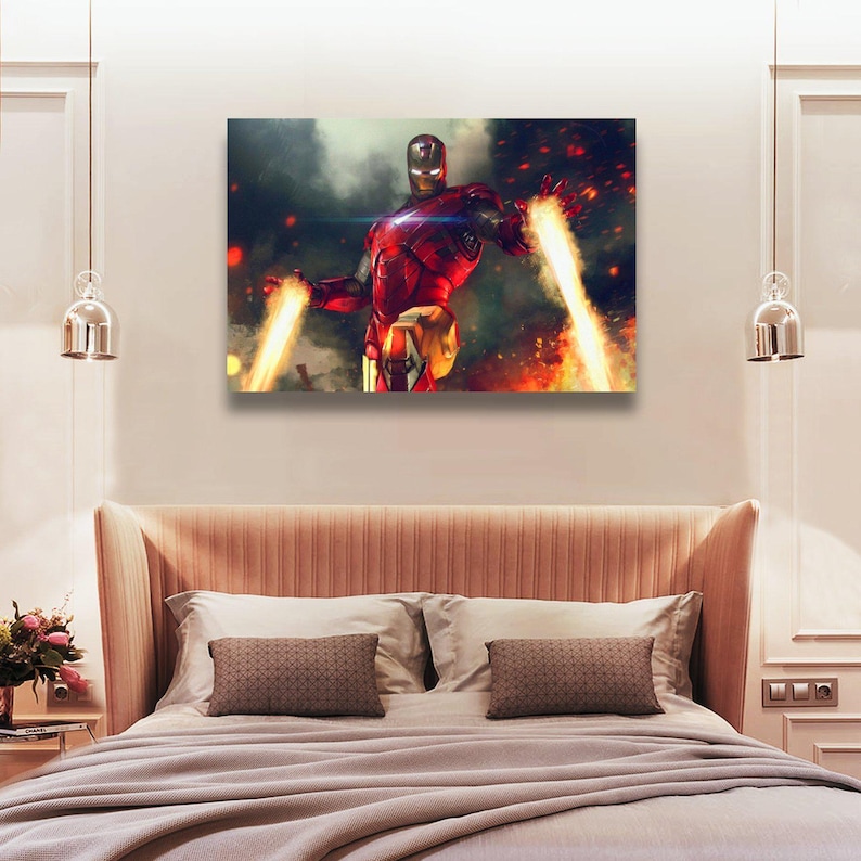 May include: A canvas print featuring Iron Man in a dynamic pose, with his hands emitting bright yellow energy beams. The artwork showcases a red and gold armored figure against a backdrop of fiery explosions and a smoky atmosphere.