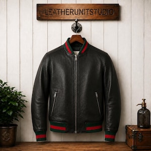 Front view of a model wearing a premium mens genuine leather jacket in textured black with vertical red and green Italian style stripes on the chest and sleeves.