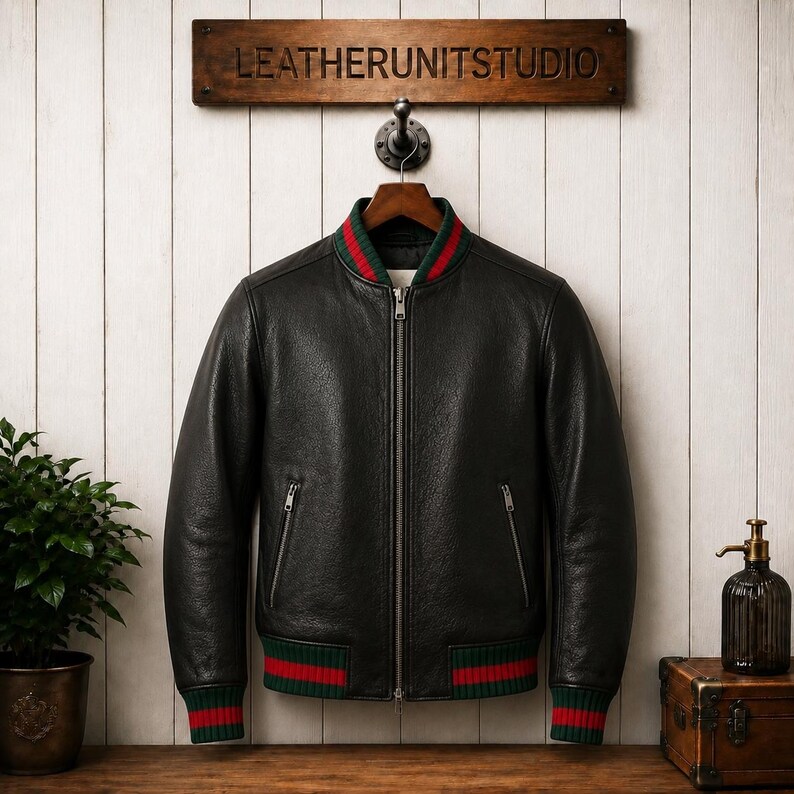 Front view of a model wearing a premium mens genuine leather jacket in textured black with vertical red and green Italian style stripes on the chest and sleeves.
