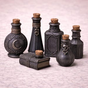 May include: An assortment of dark gray decorative bottles and a small book-shaped box, all with cork stoppers. The bottles vary in shape and design, some featuring ornate patterns and embellishments. The book-shaped box is also detailed with intricate designs.