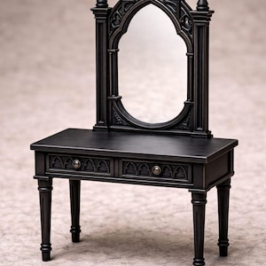 May include: A miniature black vanity with an arched mirror and two drawers. The vanity has an ornate, gothic design with decorative detailing and four slender legs. The mirror is oval-shaped and reflects the surroundings. The overall style is antique and elegant.
