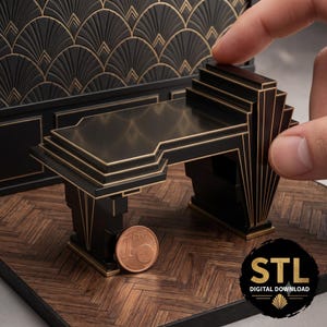 May include: A miniature black desk with gold-coloured trim and geometric stepped detailing. The desk features a flat surface and a fan-shaped side support. A one-cent coin is placed next to the desk for scale, and the text STL DIGITAL DOWNLOAD is visible.
