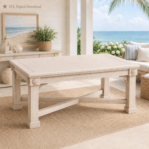 May include: A rectangular coffee table with a light beige wood finish, featuring a flat top, four sturdy legs, and an X-shaped base support. The table frame is decorated with carved seashell motifs at the top of each leg and rope detailing.