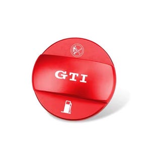 May include: A red, circular automotive part with the letters "GTI" in white. The part has a fuel pump icon and a no smoking symbol. The part is likely a fuel door cover or cap.
