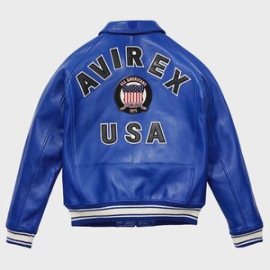 May include: A vibrant blue leather jacket with the word "AVIREX" arched across the shoulders in white block letters. Below, "USA" is displayed. A circular patch with the American flag and the words "ALL AMERICANS ESTABLISHED 1975" is centered.