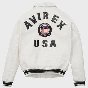 May include: White leather jacket with black and white striped trim at the cuffs and waist. The back features the text "AVIREX USA" in black lettering, with a circular emblem that includes the American flag and the words "ALL AMERICANS ESTABLISHED 1975".