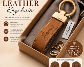 May include: A tan leather keychain with gold-tone metal hardware, featuring the name James engraved in script. The keychain includes a round ring, a rectangular tag labeled GIPYON, and two extra rings, all presented in a box with a pouch.