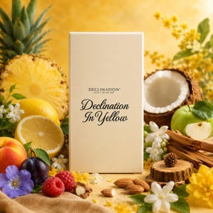 May include: A rectangular cream-colored perfume box with the text Declination extrait de parfum and Declination In Yellow printed in black. The box is surrounded by pineapple, lemon, peach, plum, raspberry, coconut, apple, and white flowers.