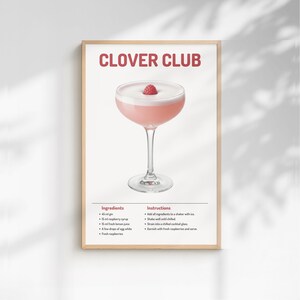 May include: A framed print featuring a Clover Club cocktail recipe. The image shows a pink cocktail in a stemmed glass, garnished with a raspberry. The title "CLOVER CLUB" is displayed in red. Ingredients and instructions are listed below.