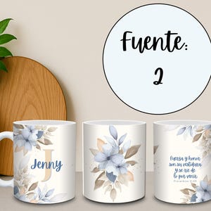 May include: White ceramic mug featuring a floral design with blue and beige watercolor flowers and leaves. The mug has the name "Jenny" and a large initial "J". The mug also has a bible verse in Spanish.