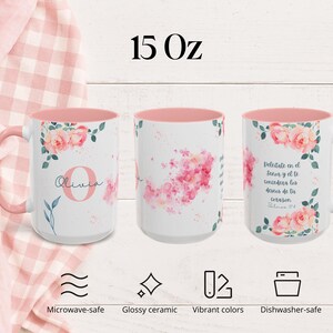 May include: Three white 15 oz ceramic mugs with pink interiors and handles. Each mug features floral designs and text. One mug has the name "Olivia", another has a pink floral design, and the third has Spanish text. The mugs are microwave and dishwasher safe.
