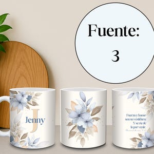 May include: White ceramic mug featuring a floral design with blue and beige accents. The mug has the name "Jenny" and the letter "J" printed on it. The mug also has a quote in Spanish.