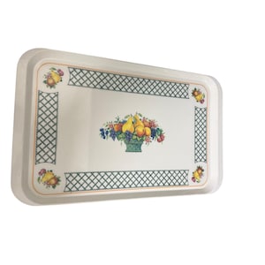 May include: A rectangular white serving tray featuring a central illustration of a fruit basket containing yellow pears, peaches, and grapes. The tray is decorated with a green lattice border pattern and small fruit clusters in each corner.