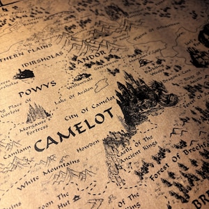 May include: A detailed map with a vintage aesthetic, featuring hand-drawn illustrations of castles, forests, and mountains. The map includes the word "Camelot" and other place names in a stylized font, printed on aged paper.