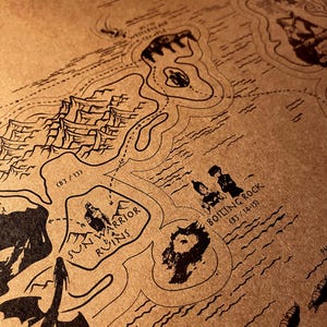 May include: A fantasy map illustration in black ink on tan paper, depicting islands, mountains, and water. The map includes labels such as "Sun Warrior Ruins" and "Boiling Rock". A dragon silhouette is also present, enhancing the fantasy theme.
