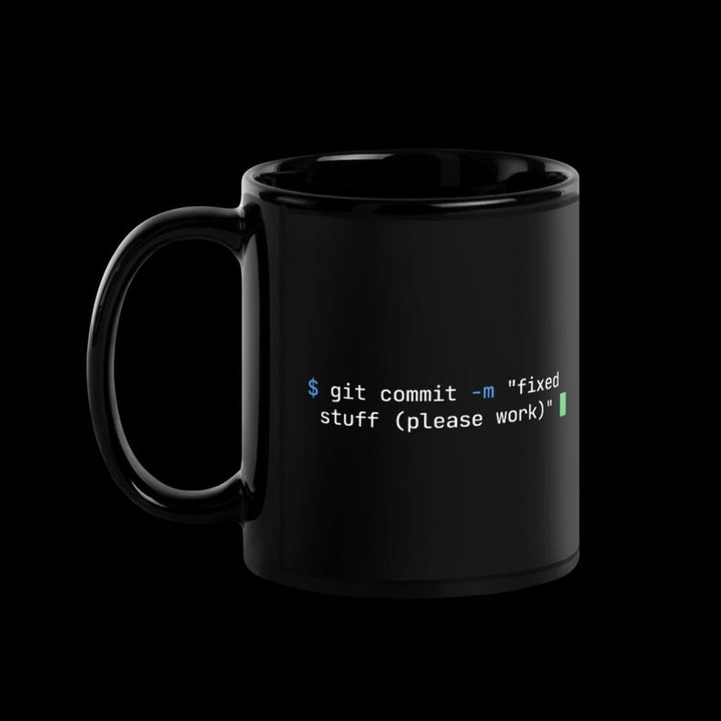 Side view of black glossy programmer mug with handle on left — git commit coding humour ceramic cup for software engineers.