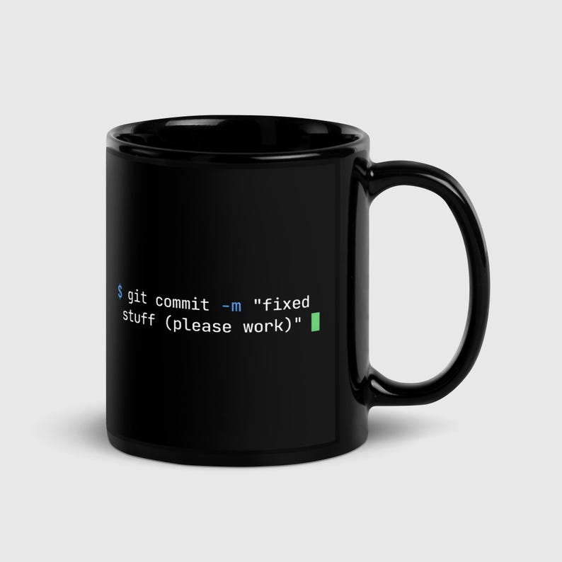 Black glossy 11oz ceramic mug with git commit terminal command printed in syntax-highlighted text — developer gift for programmers and software engineers