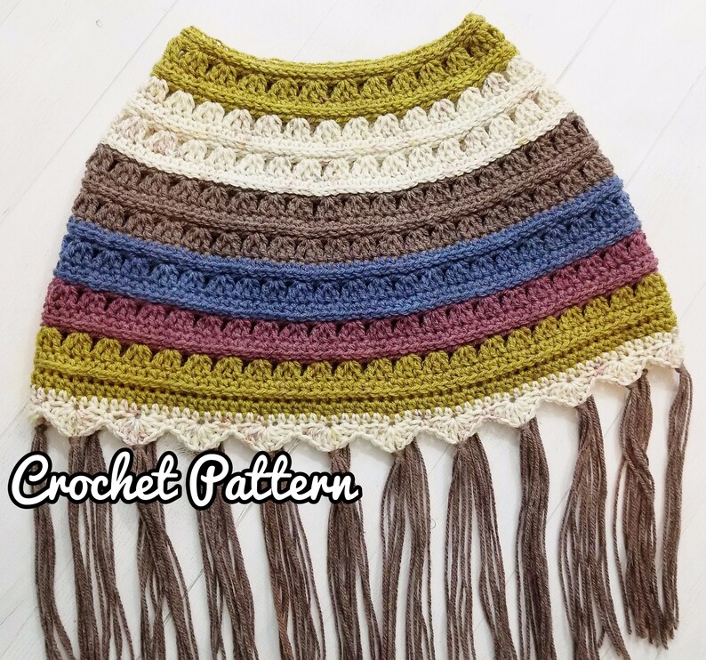 May include: Crochet pattern for a colorful striped poncho with fringe. The poncho is made with a variety of colors, including mustard yellow, brown, blue, and pink. The poncho has a scalloped edge and is finished with a fringe.