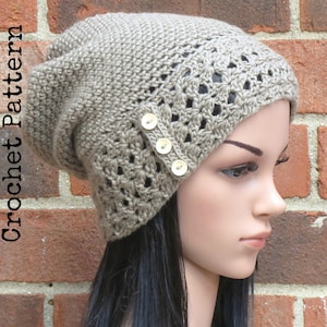 May include: A beige crocheted beanie with a lacy pattern and four decorative buttons. The beanie is slouchy and has a fold-over brim.