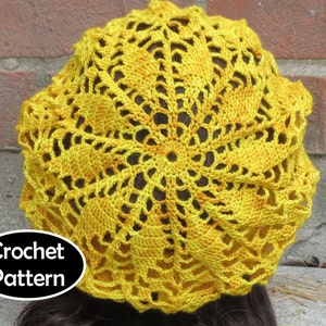 May include: A yellow crochet beret with a lacy design. Crochet Pattern.