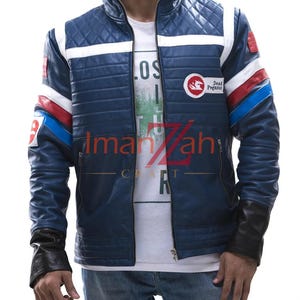 May include: A blue leather jacket with a quilted shoulder pattern, a stand-up collar, and a front zipper. The jacket features white, red, and blue stripes on the sleeves and a circular patch on the chest with the text Dead Pegasus.
