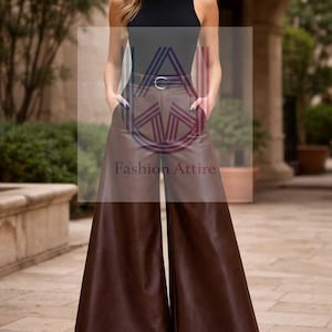 May include: A woman's ensemble comprising a black sleeveless roll-neck top and brown wide-leg faux leather trousers. The trousers have a high waist and a belt. The outfit is completed with black pointed-toe heels. The text "Fashion Attire" is visible.