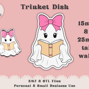 May include: A digital design for a trinket dish featuring a white ghost with a pink bow reading a tan book. The text reads Trinket Dish, 15mm & 25mm tall walls, 3MF & STL Files, Personal & Small Business Use, and Instant Digital Download.