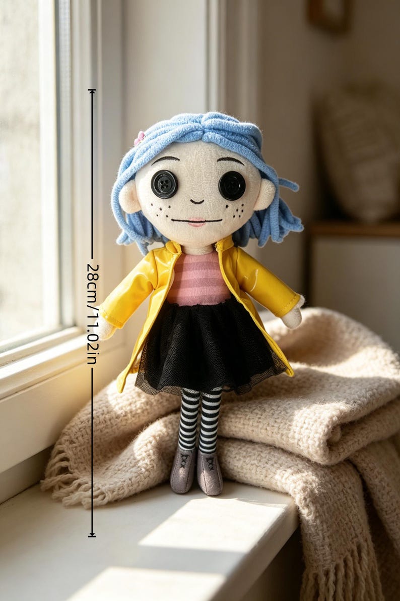 May include: A plush doll with button eyes, blue hair, and freckles, wearing a yellow coat, black skirt, and striped stockings. The doll is 11.02 inches (28 cm) tall.