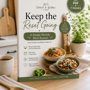 May include: A cookbook titled "Keep the Reset Going" by Velvet & Willow, featuring a simple weekly meal system. The cover is white with green accents and includes images of pasta and a chickpea dish. The book promises easy, flexible meals.