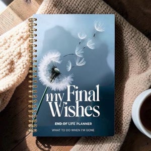 May include: A spiral-bound planner with a dark blue cover featuring a white dandelion graphic and the text "my Final Wishes END OF LIFE PLANNER WHAT TO DO WHEN I'M GONE" in white lettering. The planner has a gold-colored metal spiral binding.