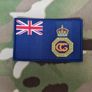 May include: A white ceramic mug with a black handle and the text "But First, Coffee" in a bold, black font. The mug is sitting on a wooden surface. The mug is approximately 4 inches tall.