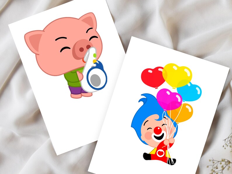 May include: Two white cards with cartoon illustrations. One features a pink pig playing a wind instrument, wearing a green shirt and purple pants. The other shows a clown holding heart-shaped balloons in red, yellow, pink, blue, and orange.