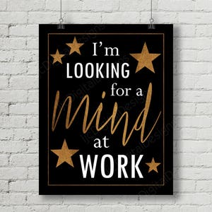 May include: Black poster with gold stars and text that reads "I'm looking for a mind at work." The words are in white and gold, with a gold border.