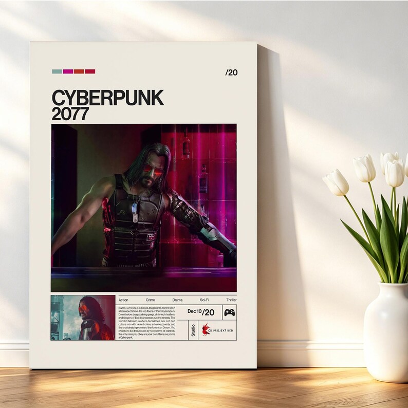 May include: A framed poster for the video game Cyberpunk 2077. The poster features a central image of a character with red-tinted eyes and a cybernetic arm. The title "CYBERPUNK 2077" is displayed in bold black letters. The poster is set against a neutral background.