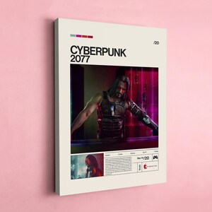 May include: A framed poster for "Cyberpunk 2077" featuring a man with long hair and cybernetic enhancements. The poster has a cream-colored background with the title in bold black letters. Additional text includes the release date and genre.