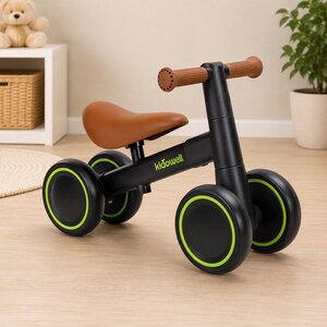 May include: A black balance bike with a brown seat and brown handlebars. The frame features the text kidowell in green. The bike has four black wheels with bright green circular accents on the rims, designed for stability and movement.