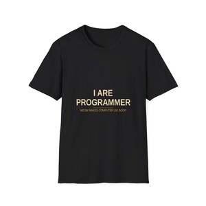 Könnte beinhalten: Schwarzes T-Shirt mit goldfarbenem Text "I ARE PROGRAMMER". Darunter steht in kleinerer goldener Schrift der Satz "MEOW MAKES COMPUTER GO BOOP". Das T-Shirt hat kurze Ärmel und einen Rundhalsausschnitt.