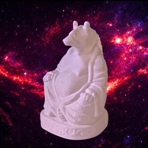 May include: A white statue of a bear in a seated pose, with its hands resting on its lap. The bear has a serene expression and is draped in flowing robes. The background is a vibrant depiction of a nebula with shades of red, purple, and pink.