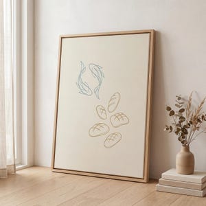 May include: A framed art print featuring a minimalist design. Two blue fish swim above several brown bread loaves. The artwork is set against a cream-colored background, with a natural wood frame.