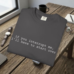 May include: A set of three ceramic mugs with a speckled, matte finish in cream, light grey, and dark grey. Each mug has a simple, minimalist design, ideal for coffee or tea.