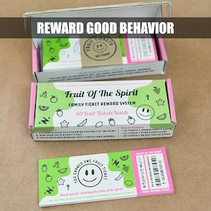 May include: A family ticket reward system with the text "Fruit Of The Spirit" and "Reward Good Behavior". The box contains 50 tickets with fruit illustrations and a smiling face. One ticket is visible.